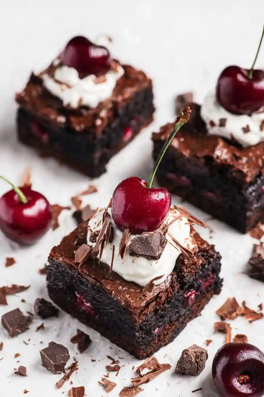 Black-Forest-Brownies-post1 Decorated black forest brownie slice with whipped cream and cherry