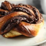 Chocolate filling spread on brioche dough before shaping